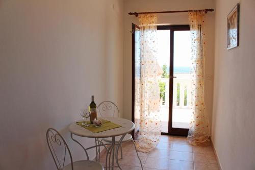 a dining room with a table and chairs and a window at Apartments by the sea Sveta Nedilja, Hvar - 110 in Sveta Nedelja