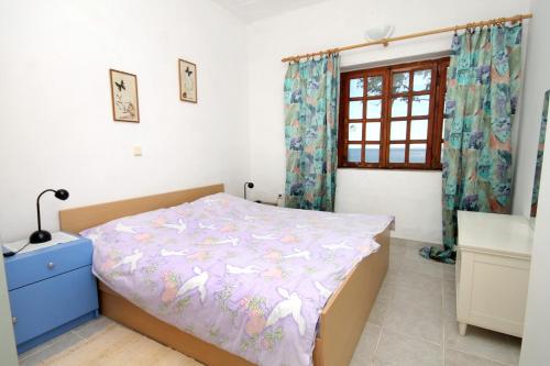 a small bedroom with a bed and a window at Seaside holiday house Milna, Hvar - 114 in Hvar