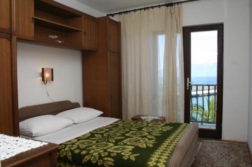 a bedroom with a bed and a window with a view at Apartments by the sea Sucuraj, Hvar - 136 in Sućuraj