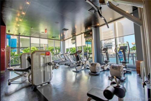 a gym with a bunch of treadmills and machines at Miami Beach Glam, Ocean Views & Elegance -28B in Hallandale Beach