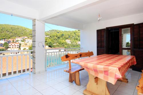 a table on a balcony with a view at Apartment Brna 147a in Smokvica