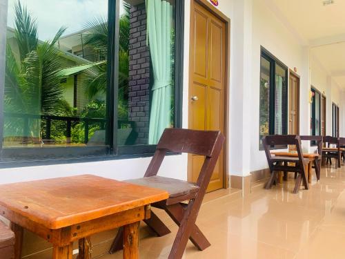 a wooden bench sitting in front of a window at View Garden Resort in Phi Phi Islands