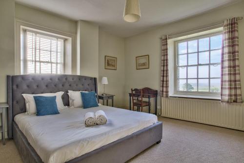 a bedroom with a large bed with two towels on it at Timberley Farm by Group Retreats in Pulborough