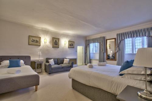 a large bedroom with two beds and a couch at Fawley Court by Group Retreats in Hereford