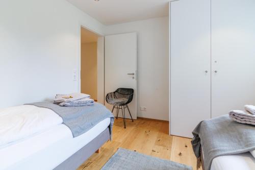 a bedroom with a bed and a chair at Chalet Alpenheim 1 in Wengen