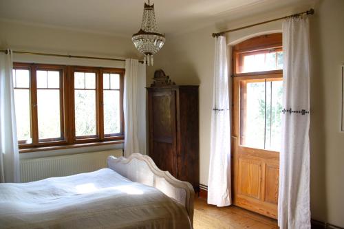 a bedroom with a bed and a window and a door at Villa Sunnyside 1 in Dresden