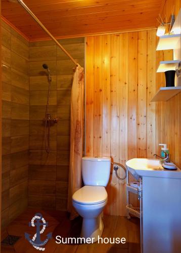 a bathroom with a toilet and a sink at Morska Enklawa in Gąski