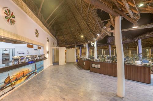 a large room with a large ceiling and a food court at Kiwengwa Beach Resort in Kiwengwa