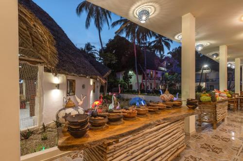 a display of pots and pans on a table in a house at Kiwengwa Beach Resort in Kiwengwa