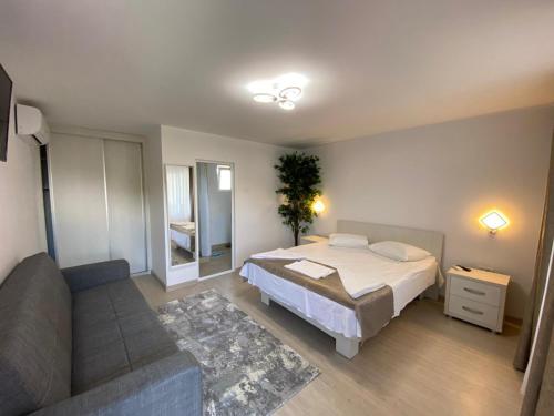 a bedroom with a bed and a couch at Suzana Garden in Venus
