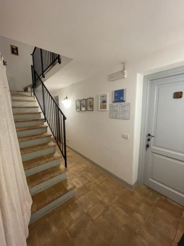 a hallway with a staircase and a door at Il Borgo Affitacamere in Castiglione in Teverina