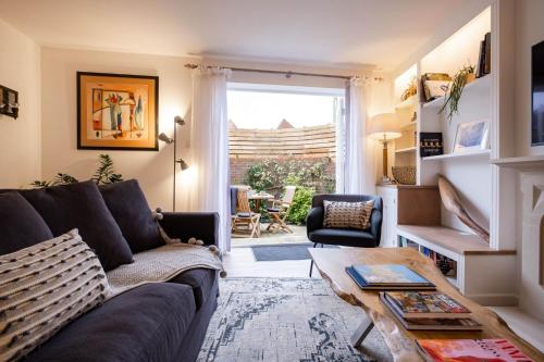 a living room with a couch and a table at Nutmeg House in Lymington
