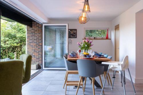 a dining room with a table and chairs at Furzedown Farm House in Hythe