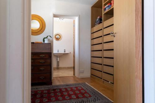 a hallway with a dresser and a sink in a room at Nye Creek Or Nye Creek & Little Nye in Milford on Sea