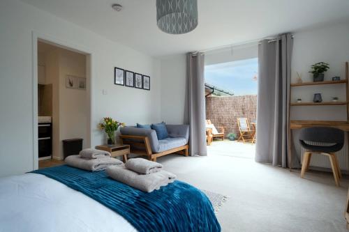 a bedroom with a bed with towels on it at Nye Creek Or Nye Creek & Little Nye in Milford on Sea