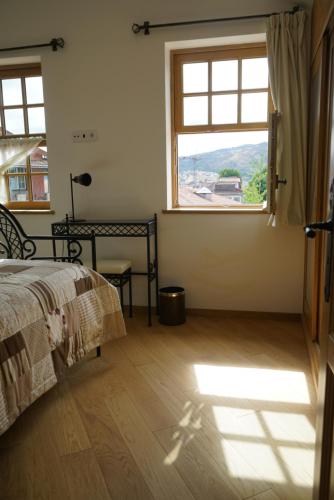 a bedroom with a bed and a large window at Casa Guardiao in Chaves