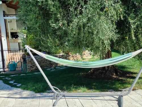 a hammock sitting in front of a tree at B&B Villa Letizia in San Vito Rimini