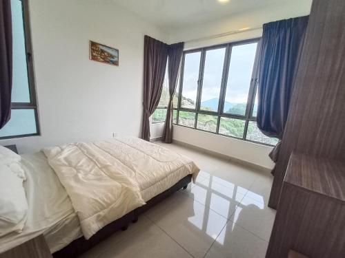 a bedroom with a bed and a large window at Homestay at Palas Horizon with sunrise view in Brinchang