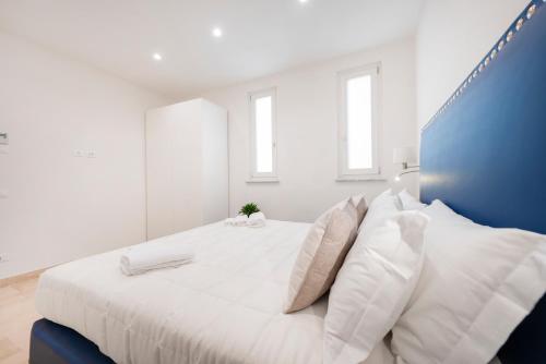 a white bedroom with a large white bed with pillows at Divo Apartments - Spanish Steps in Rome