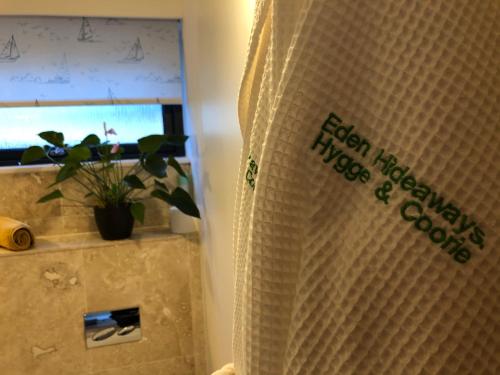 a shower curtain in a bathroom with a potted plant at Orchard Hideaway in Kelso