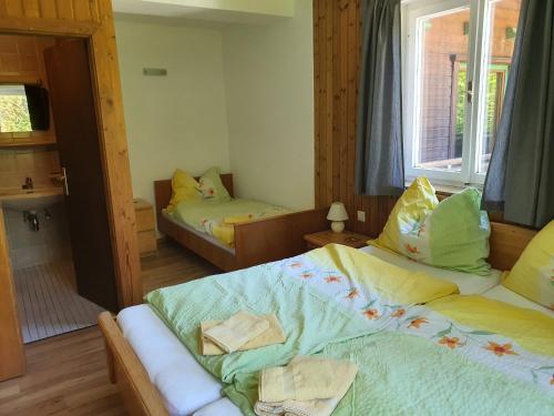 a small bedroom with two beds and a window at Landhaus Alexa in Eben im Pongau