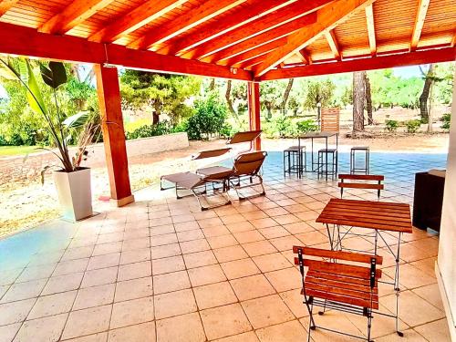 a patio with benches and tables and a pavilion at Villa Costanza in Bari