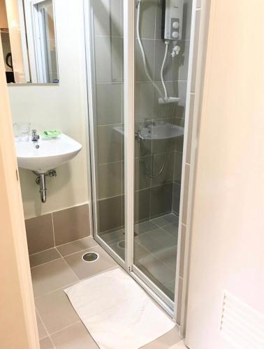 a bathroom with a shower and a sink at Brenthill Premium Condo Baguio City with Generator in Baguio