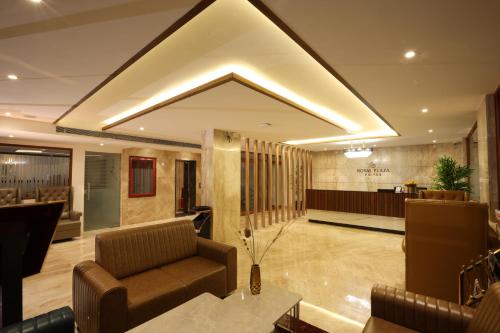 a lobby with a couch and a table at Royal Plaza Suites by RAK Rooms, Mangaluru in Mangalore