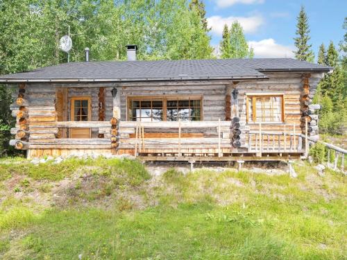 a log cabin with a porch on a hill at Holiday Home Luminalle by Interhome in Ruka