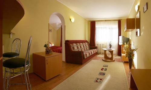 a living room with a couch and a chair at Hotel Riviera in Sinaia