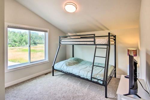 a bedroom with two bunk beds and a window at Red Lodge Home with Patio about 1 Mi from Downtown! in Red Lodge