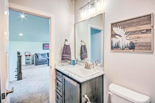 a bathroom with a sink and a toilet and a mirror at Red Lodge Home with Patio about 1 Mi from Downtown! in Red Lodge
