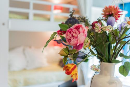 a vase with a bunch of flowers in it at Flo's Atelier - Family studio NOTE studio is adjacent to Flo's apartment in Amsterdam