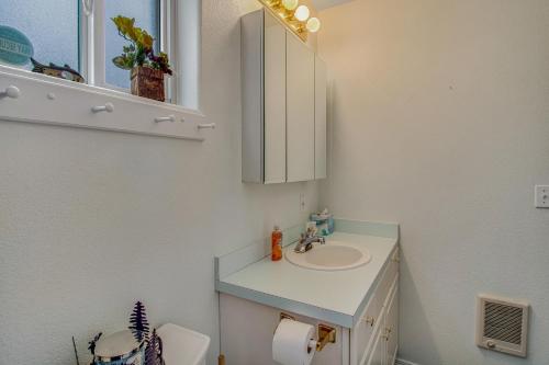 a bathroom with a sink and a mirror and a toilet at Syringa House in McCall