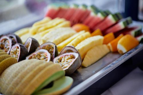 a tray of different types of sandwiches and fruit at Ednam House Hotel in Kelso