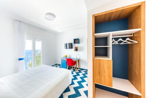 a bedroom with a bed and a desk at La Vigna di Bacco in Furore