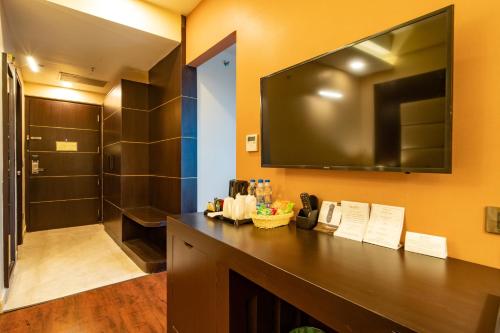 a bathroom with a large television on the wall at Vivanta Jamshedpur, Golmuri in Jamshedpur