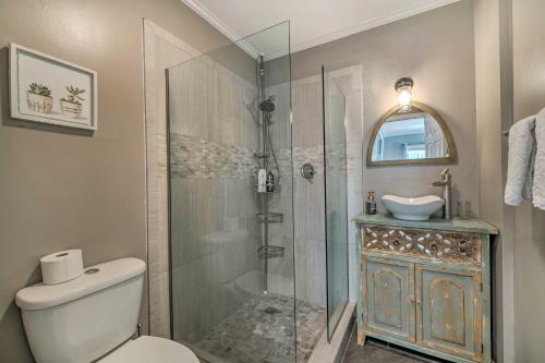 a bathroom with a shower and a toilet and a sink at Walk to Mount Dora Historic District Cozy Home! in Mount Dora
