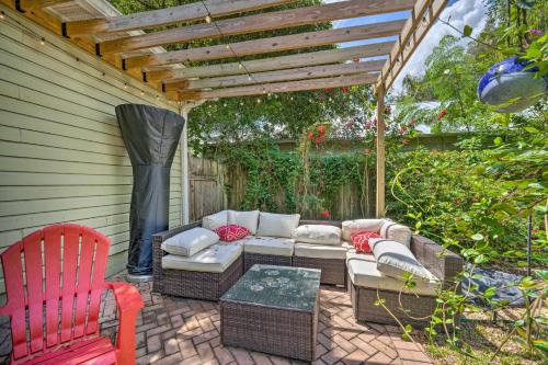 a patio with a couch and a wooden pergola at Walk to Mount Dora Historic District Cozy Home! in Mount Dora
