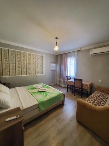 a bedroom with a bed and a chair and a table at Beehives in Kutaisi