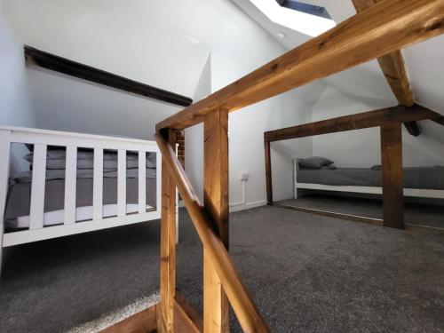 a room with two bunk beds and a ladder at Hursley Rooms - The Dolphin in Winchester