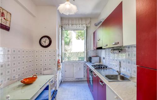 a kitchen with a sink and a clock on the wall at 1 Bedroom Stunning Apartment In Genova in Genoa