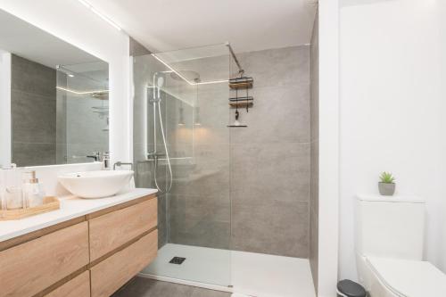 a bathroom with a shower and a sink and a toilet at Roy Boston Marbella by Florentia Homes in Marbella