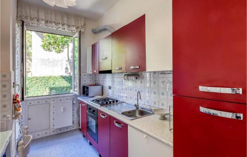 a kitchen with red and white cabinets and a sink at 1 Bedroom Stunning Apartment In Genova in Genova