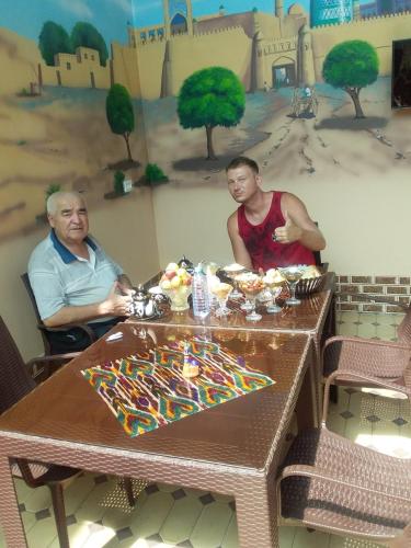 a man and a woman sitting at a table at Khiva Khan Hotel in Khiva