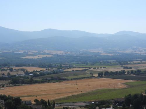 an aerial view of a field with mountains in the background at Il Borgo Affitacamere in Castiglione in Teverina
