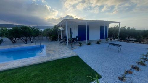 a villa with a swimming pool and a house at Villa Edna Crete in Agios Nikolaos