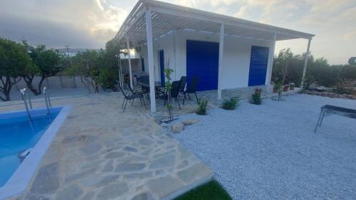 a house with a swimming pool and a patio at Villa Edna Crete in Agios Nikolaos