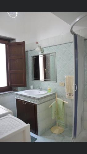 a bathroom with a sink and a mirror at Casa Vacanze Da Laura in San Vito lo Capo