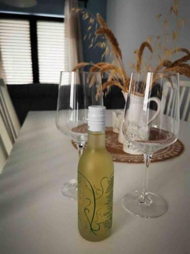 two glasses and a bottle of wine on a table at Meraki Homestay Kanali in Kanali